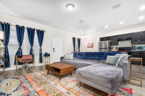a living room with a couch and a table at Beautiful Home, Walk to UF, Newly built in Gainesville