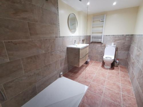une salle de bain avec toilettes et lavabo dans l'établissement Au repos du Dourmeur, à Saint-Évarzec
