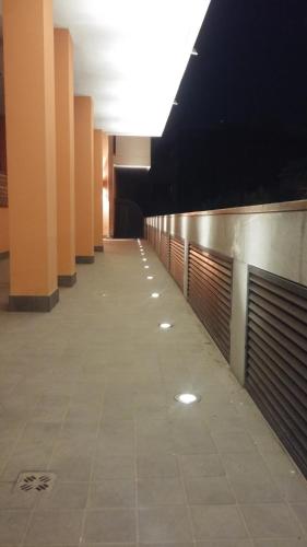 an empty hallway in a building with orange columns at Aparthotel Capitol in Grado