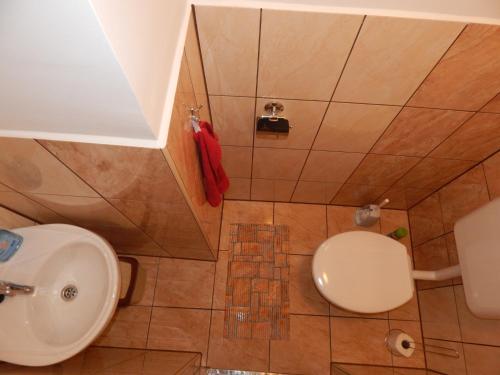 a bathroom with a toilet and a sink at Tündér Szálló Eplény in Eplény