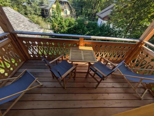 a deck with a table and chairs on it at Haus Christl&Franz in Bad Aussee