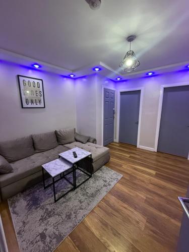 a living room with a couch and a table at Luxury Modern Apartment, Sleeps 4 and Games Room in Bolton