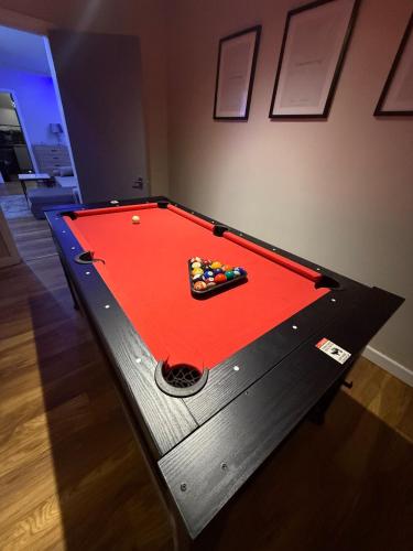 a pool table in a room with afits at Luxury Modern Apartment, Sleeps 4 and Games Room in Bolton