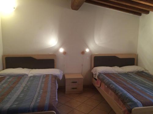 a room with two beds in a room at Central Station Apartments in Pisa