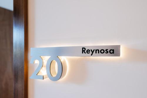 a door sign that reads reynossa in front of a door at Casa Castillo Condesa in Mexico City