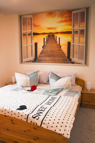 a bed with a painting of a pier at Kleine Mariken in Zingst