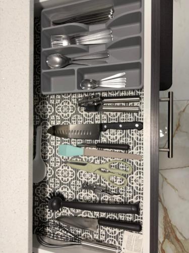 a refrigerator filled with lots of silver utensils at THE GUEST HOUSE WEST EDMONTON Mall in Edmonton