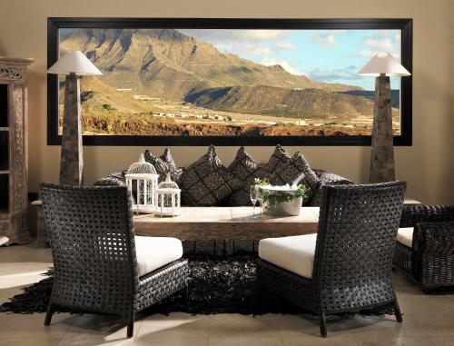 a living room with a painting of a mountain at Royal Garden Villas, Luxury Hotel in Adeje