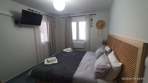 a bedroom with a bed with two towels on it at Aegean Villita on beach apartment in Kalymnos