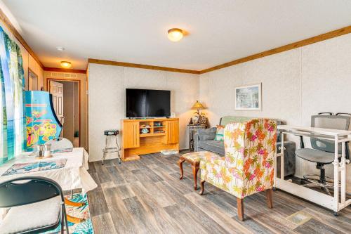 a living room with a couch and a tv at Pet-Friendly Punta Gorda Getaway with Fire Pit! in Punta Gorda