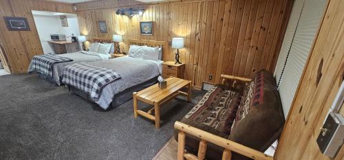 a hotel room with two beds and a couch at Willard Munger Inn in Duluth