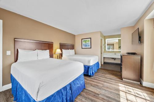 Postel nebo postele na pokoji v ubytování Executive Inn