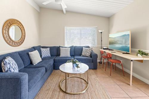 a living room with a blue couch and a desk at Los Aguajes in Santa Barbara