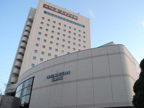 a building with a sign on the side of it at Route Inn Grantia Komaki in Komaki