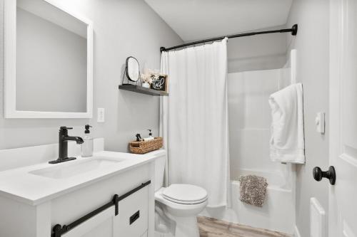 a white bathroom with a sink and a toilet at Brown Park Ranch in Bend