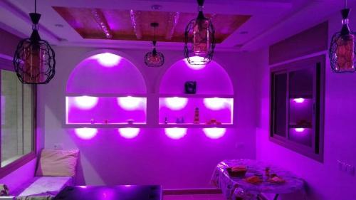 a living room with purple lights on the wall at Basma House , Peaceful Stay with Stunning Views in Ksar es Sghir