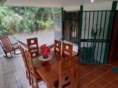 a wooden table and chairs in a room at Finca Bosques de Osa in Palmar Sur