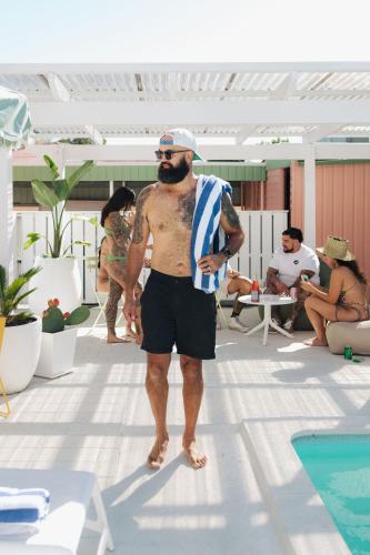 a man standing next to a swimming pool at The Mayfair in Hastings