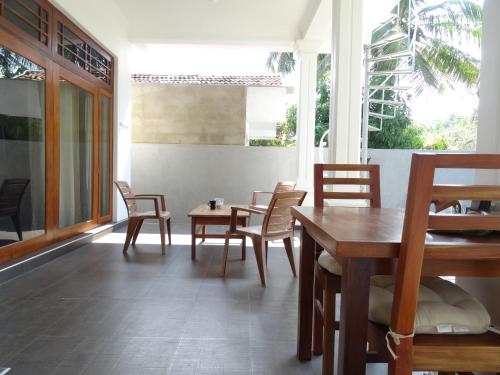a dining room with chairs and a wooden table at Ok Cabana Negombo in Negombo