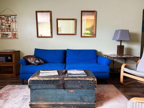 a blue couch and a table in a living room at Peaceful Hideaway in Central Fargo in Fargo