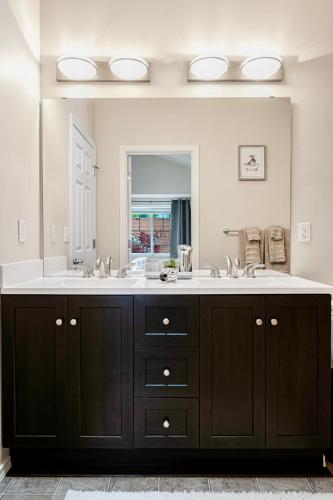 a bathroom with a large sink and a large mirror at Modern Luxury Home, Green Lake, Seattle in Seattle