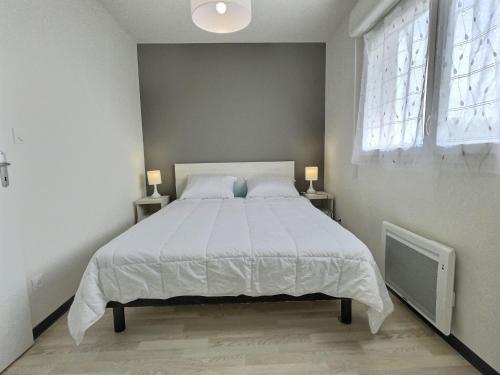 - une chambre dotée d'un grand lit avec des draps blancs et une fenêtre dans l'établissement Maisonette near Valras-Plage Beach, à Sérignan