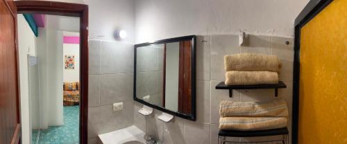 a bathroom with a sink and a mirror at Casa Margarita Mexican Warmth Await! in Cozumel