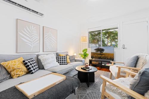 a living room with a couch and a table at Spacious 3-Bed House in Leafy Paddington in Brisbane