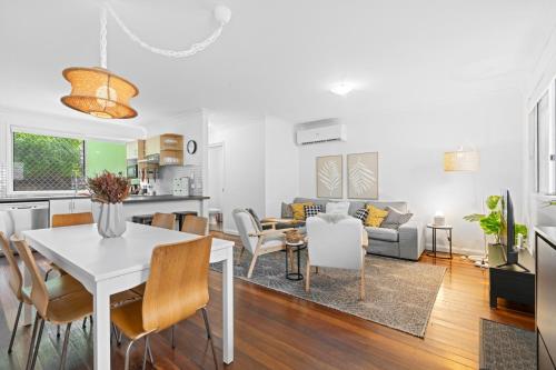 a living room with a white table and chairs at Spacious 3-Bed House in Leafy Paddington in Brisbane