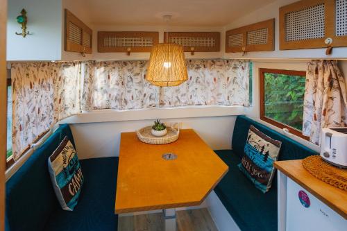 a dining room with a table and chairs in a train at Poinciana at Cooee Bay in Yeppoon
