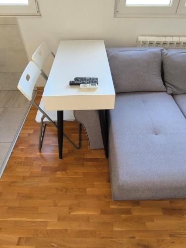 a table with a keyboard on top of a couch at Apartment for a day, Zemun, Altina, two rooms in Belgrade