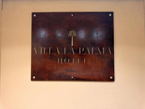 a sign for a hotel on a wall at Villa La Palma Hotel in Tequila