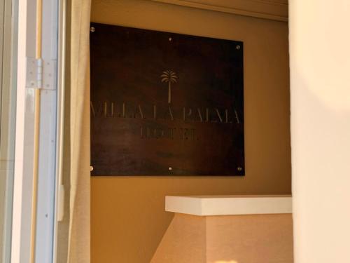 a picture of a hotel sign on a wall at Villa La Palma Hotel in Tequila