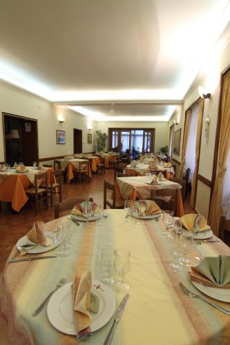a long table with plates and glasses on it at Hotel Ristorante La Casareccia in Fiuggi