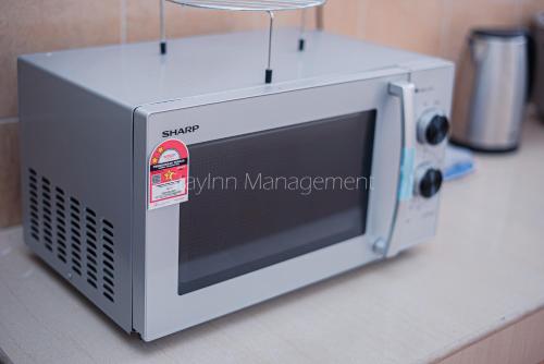 a microwave oven sitting on top of a counter at PD 4R3BR 20pax Private Pool Near To the beach in Port Dickson