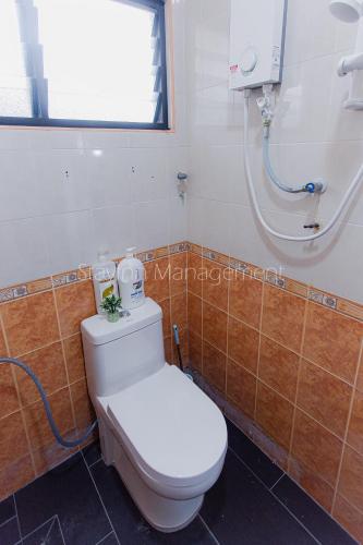 a bathroom with a toilet and a shower at PD 4R3BR 20pax Private Pool Near To the beach in Port Dickson