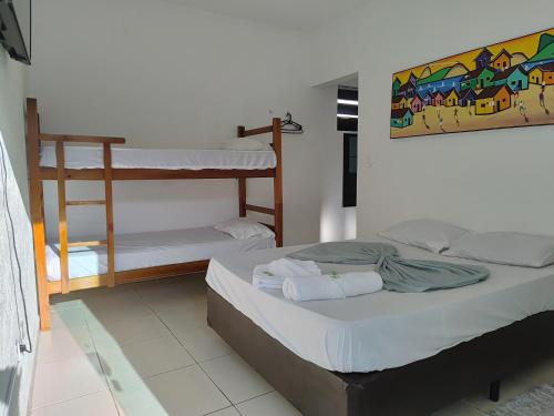 a bedroom with two bunk beds in a room at PORTO SUÍTES PERUÍBE CHECK-OUT LIVRE aos DOMINGOS in Peruíbe