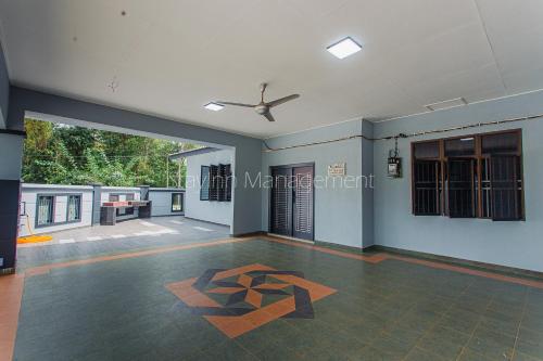 a living room with a ceiling fan and a floor at PD 4R3BR 20pax Private Pool Near To the beach in Port Dickson