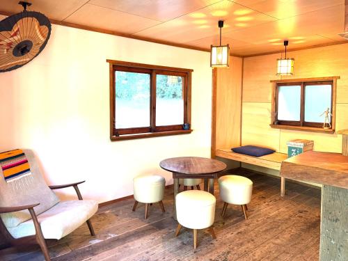 a room with a table and some chairs and a table at Sai Holiday House Ohama Beach - Max 9 ppl in Shimoda