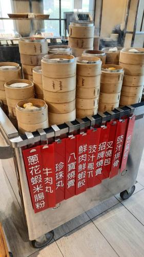a cart full of wooden bowls on a table at Kaohsiung Chateau de Chine Hotel in Kaohsiung