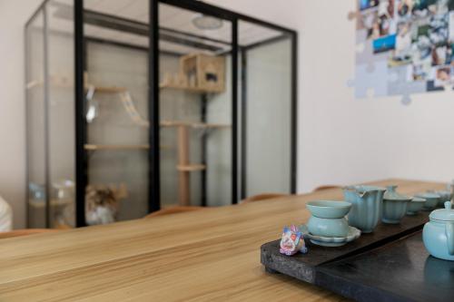 a table with blue vases sitting on top of it at Wuyi Whispering Maple in Dali