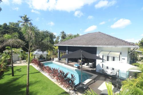 an image of a house with a swimming pool at Villa Beau Rivage in Bachok