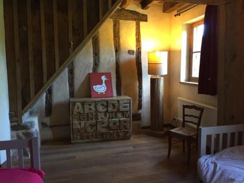 a bedroom with a bed and a room with a staircase at Country-side house close to loire-valley castles in Sargé-sur-Braye