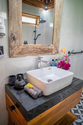 a bathroom with a sink and a mirror on a counter at Taman Swarga Villa Resort & Spa Sidemen in Sidemen