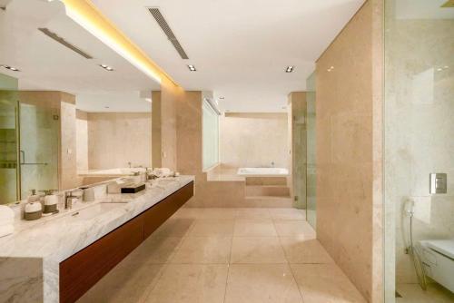 a large bathroom with two sinks and a bath tub at Danang Villas Complex in Da Nang