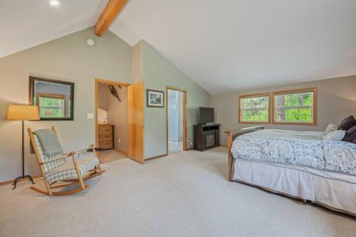 a bedroom with a bed and a chair at Bjork Creek Cabin in Leavenworth