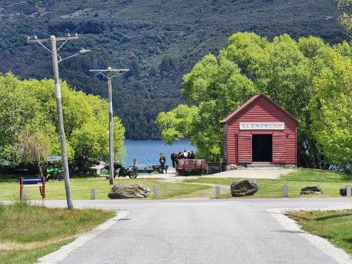 a red barn on the side of a road at Glenorchy Haven in Glenorchy