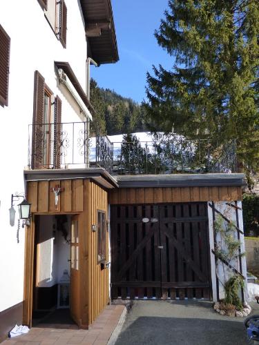 a wooden garage with a gate and a balcony at Haus Annelies Walchsee in Walchsee