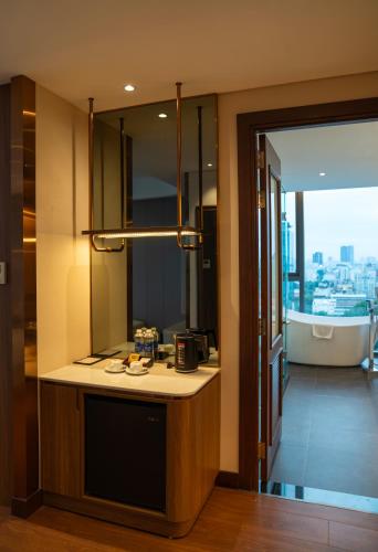 a bathroom with a sink and a bath tub at Northern Charm Hotel in Ho Chi Minh City