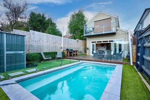a swimming pool in the backyard of a house at Bowen Street Family Retreat with Pool in Melbourne